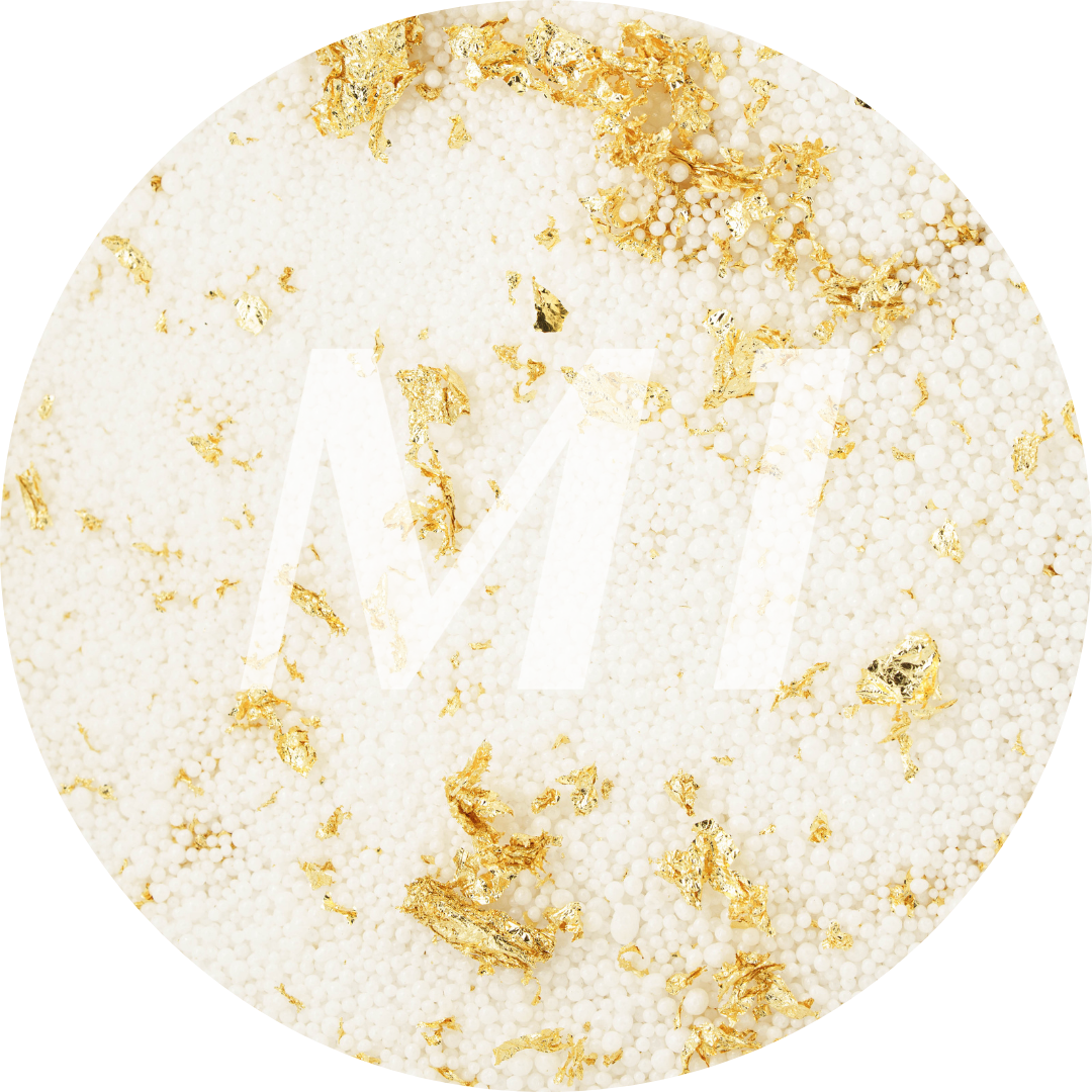 Kleurstaal van wit kaarsenzand met gouden glinsterflakes en subtiel M1-logo op de achtergrond.