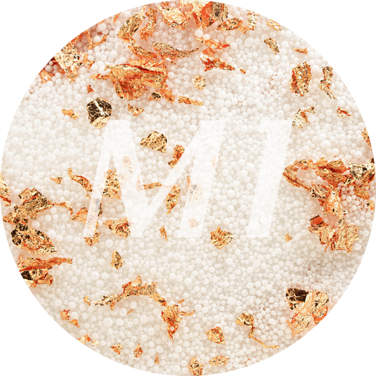 Kleurstaal van wit kaarsenzand met roségouden glinsterflakes en subtiel M1-logo op de achtergrond.