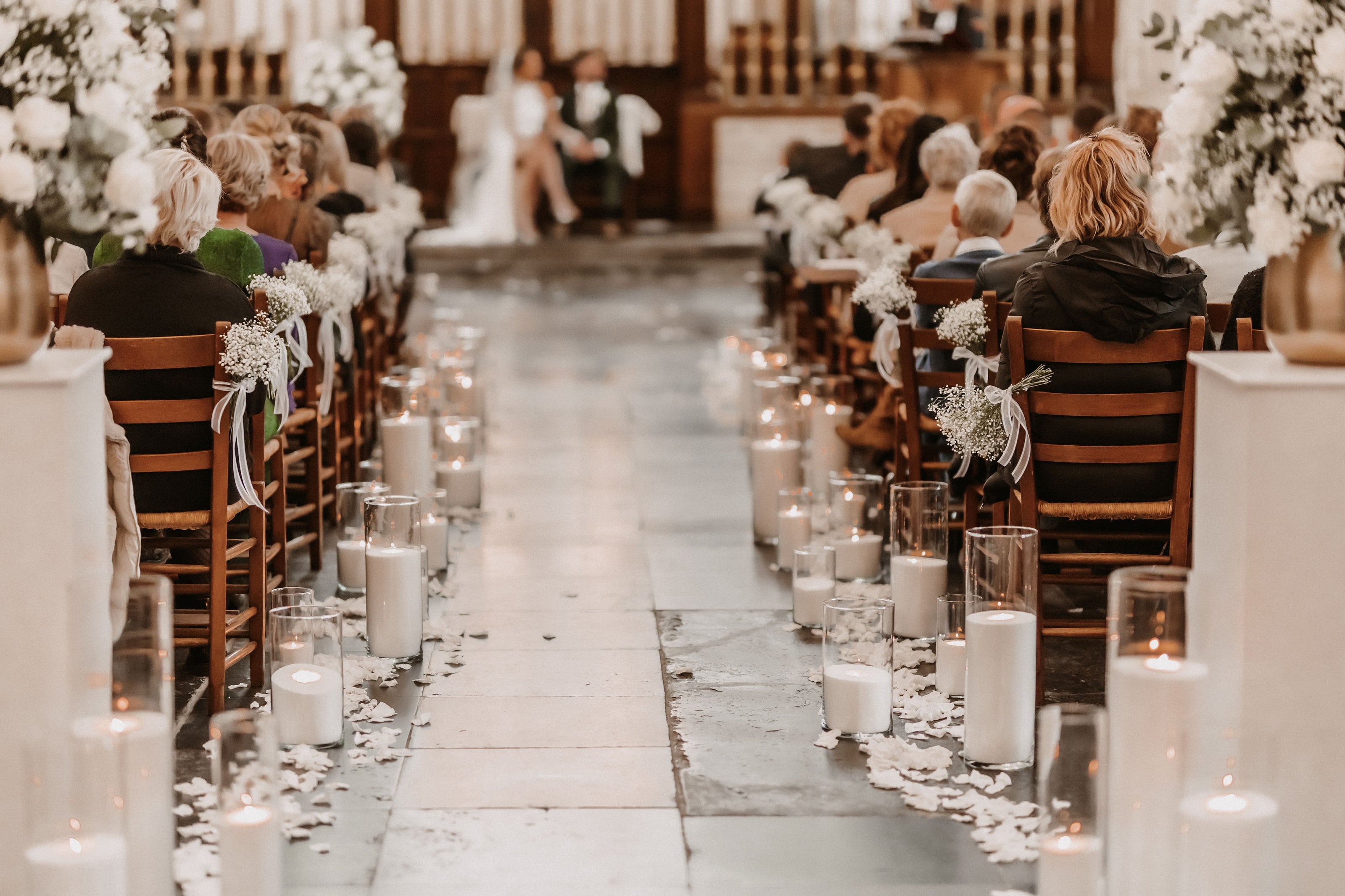 Trouwceremonie gangpad met glazen cilinders en brandende kaarsen als romantische wedding decoratie